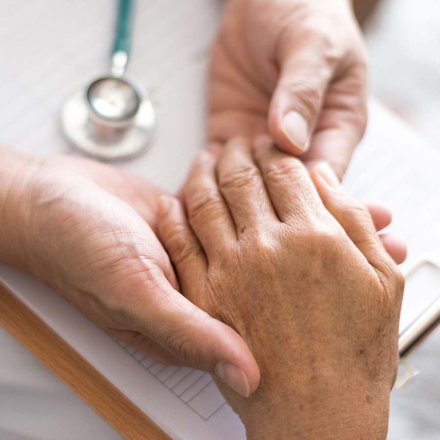 doctor holding a patient's hand